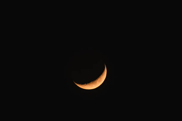 istock Waxing crescent in the sky, a view from the ground to the illuminated crescent moon. 2061603366