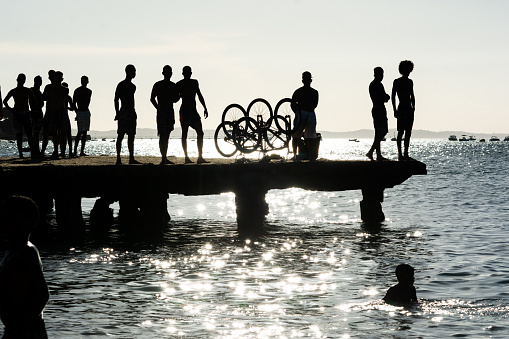 Salvador, Bahia, Brazil - March 09, 2019: young people, in silhouette, are seen having fun on the Crush bridge in the late afternoon in the city of Salvador, Bahia.