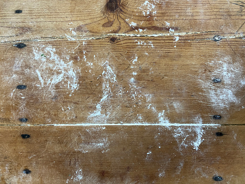 Directly above wood background with flour. Bakery countertop