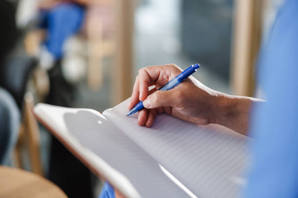 istock Close-Up of Healthcare Professional Writing Notes 2061614925