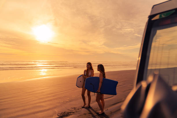istock Friends with buggy board heading to beach. 2061617332