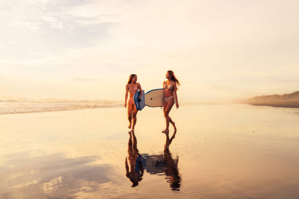 istock Carrying bodyboards on summer beach vacation having fun by sea. 2061618129