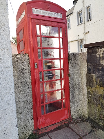 Red old telephone booth, telephone box and wall, Perth and Kinross, Scotland, England UK