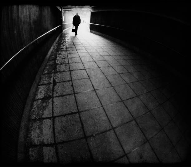 istock Silhouette of man entering a dark tunnel 2061661275