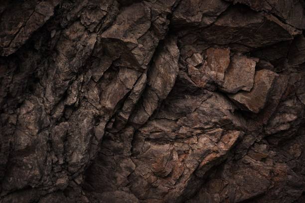 black dark brown gray stone rock granite basalt texture background. mountains surface. close-up. cracked broken crumbled. - alvenaria imagens e fotografias de stock