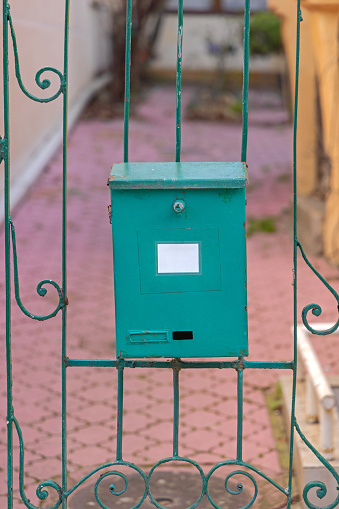 Green Metal Post Mailbox Hanging at House Gate