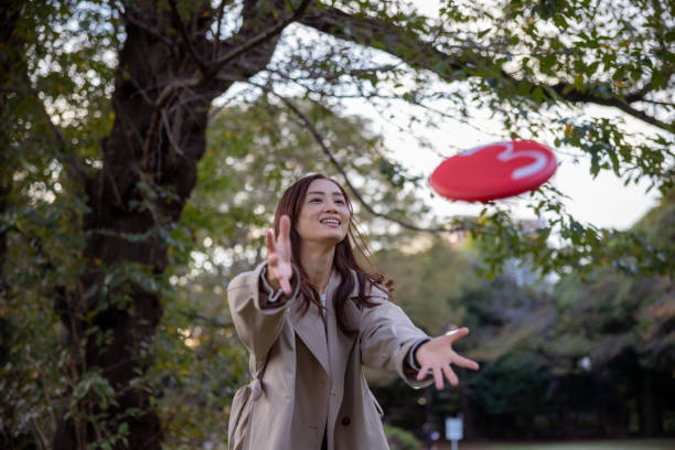 istock Woman catching flying disc in public park 2061738650