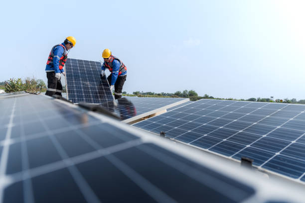 istock Male workers repair Floating solar panels on water lake. Engineers construct on site Floating solar panels at sun light. clean energy for future living. Industrial Renewable energy of green power. 2061743858