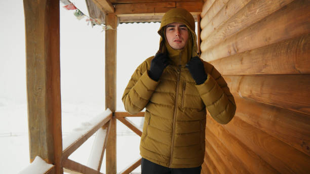 istock Young man at mountain cabin in winter 2061753746