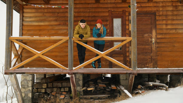 istock Young couple at mountain cabin in winter 2061755813