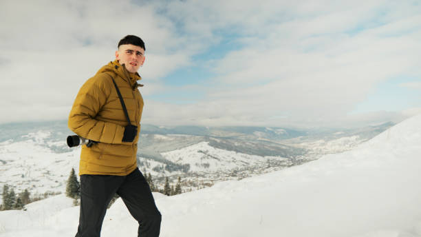 istock Young man photographer in winter 2061759472