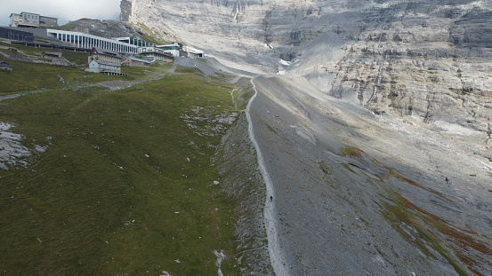 Aerial view of mountain biker on mountain ridge, Swiss Alps