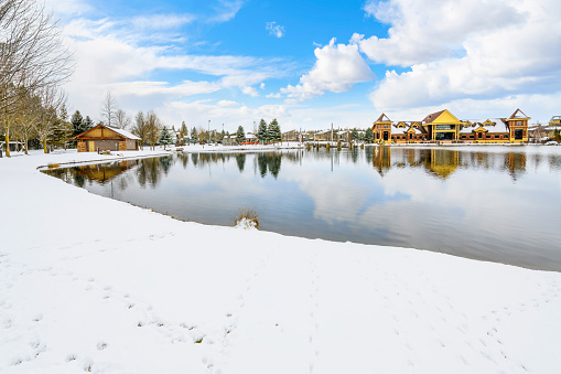 Riverstone public park and lake during winter with snow on the ground, in the Riverstone commercial and residential development in downtown Coeur d'Alene, Idaho.