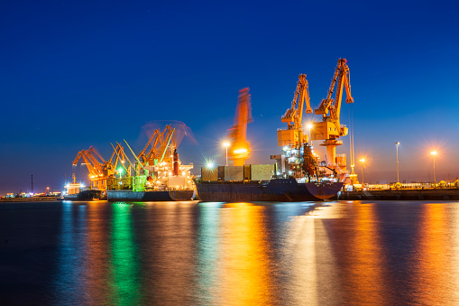 Gantry crane and cargo ship in the evening, Shipping and logistic concept