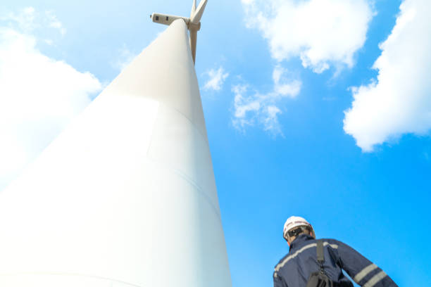 istock engineer working in fieldwork outdoor. Technicians of wind turbine checking and maintenance Electricity wind generator.. operation of wind turbines that converts wind energy into electrical energy 2061796360