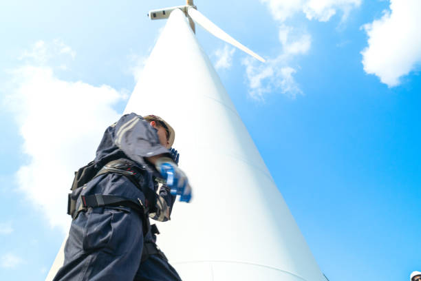 istock engineer working in fieldwork outdoor. Technicians of wind turbine checking and maintenance Electricity wind generator.. operation of wind turbines that converts wind energy into electrical energy 2061806795