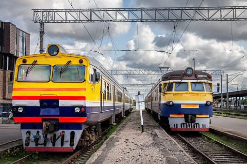 SIGULDA, LATVIA - AUGUST 21, 2023: Selective blur on a regional and suburban trains, a diesel DMU and an EMU electric train of latvian railways, russian design, ready for departure in Riga station.