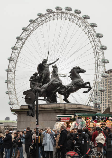 London, UK - Dec 25, 2023 - Bronze Boadicea and Her Daughters sculpture (Queen of the Celtic Iceni tribe) located at the Westminster Bridge with London eye in background. The Chariot of Boadicea, space for text, Selective focus.