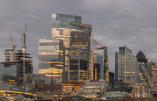 London, UK - Feb 15, 2024 - The illuminated of skyscraper in the business district of London just after sunset. View of architectural modern buildings of the city, Copy space, Selective Focus.