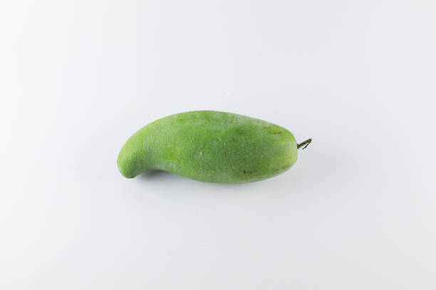 Green mango on white background. Tropical fruit. Sour and high vitamin C fruit for healthy.