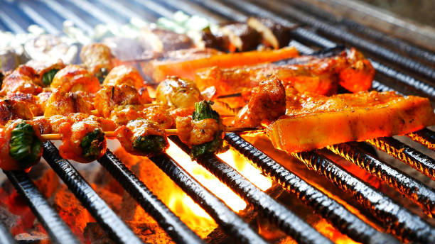 bbq barbecue grilled meat stick on fire flame with hot charcoal cooking outside. beef grilling picnic outdoor with smoke bacon spicy sausage for party. grill pork bbq on fire flame - barbecue grill broiling barbecue vegetable stock-fotos und bilder