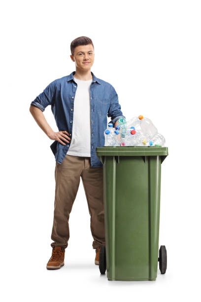istock Young man standing behind a bin with plastic bottles for recycling 2061897892