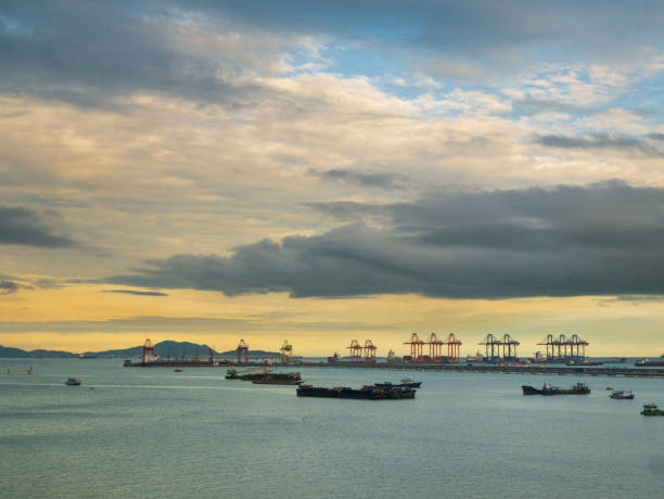 istock Logistic shipping quay boat in twilight sky night Engineering crane depot at logistic export terminal control. Warehouse freight background container yard loading quayside harbor port Logistics. 2061915862