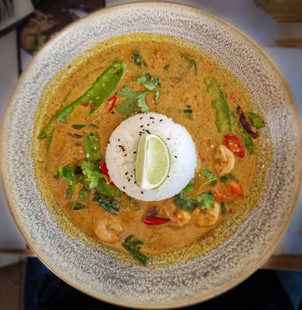 istock Shrimps in spicy curry sauce and rice on a plate. View from above 2061916413