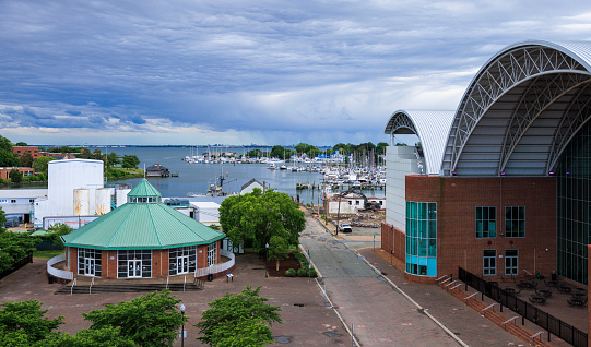 Virginia Air and Space Science Center and Carousel Dog Park in Hampton, Virginia.  View on arc and cupola roofs of the brick buildings, which are located on the shore of the Hampton River in Marina