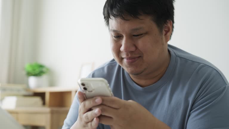 Man typing or texting message chat with friends using a mobile phone