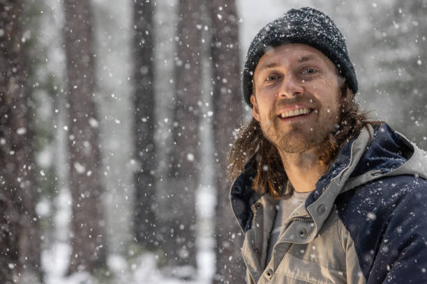 istock A man with a beard and a blue hat is smiling in the snow 2061974225