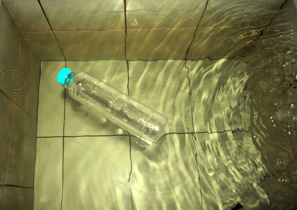 transparent glass bottle with secret message closed with a cork by the sea