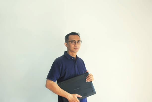 istock Male model wears reading glasses is carrying a laptop. 2062035063