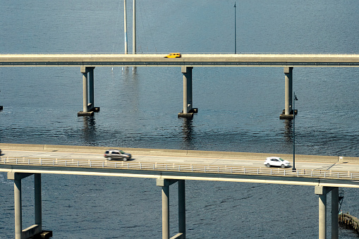 Barron Collier Bridge and Gilchrist Bridge in Florida with moving traffic. Transportation infrastructure in Charlotte County connecting Punta Gorda and Port Charlotte over Peace River.