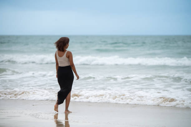 istock Woman walking towards water 2062100283