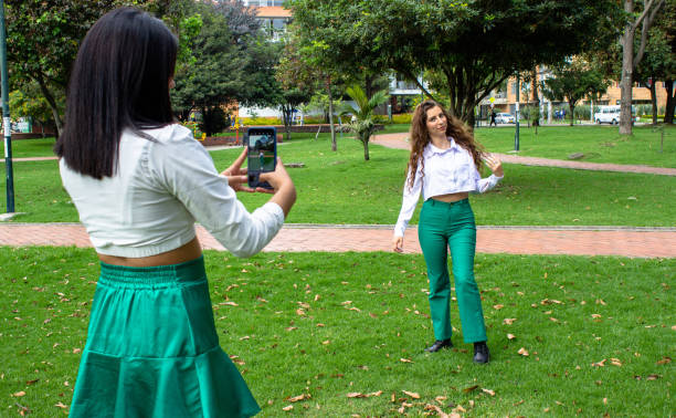 istock two beautiful young women having fun in a public park 2062115932