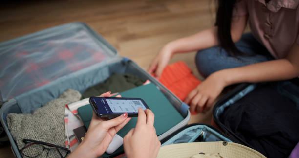 istock Young woman check and confirm digital boarding pass on app through smartphone 2062118022