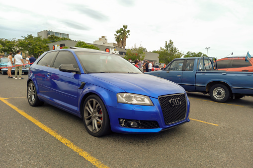 Buenos Aires, Argentina - Feb 25, 2024: Modern blue shiny sport Audi S3 at a classic car show in a parking lot. Copy space