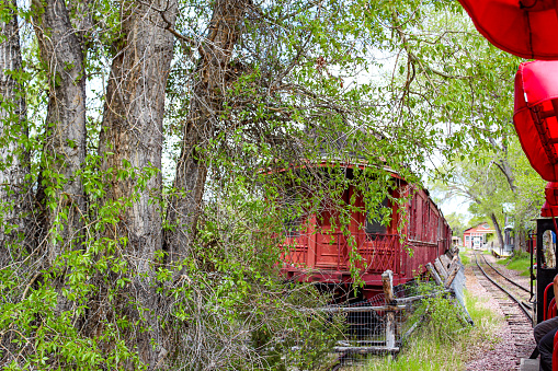 An old red railroad car sitting abandonded