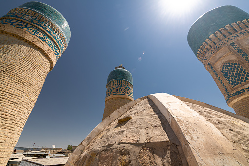 Close up on one of the towers of Old Madrasah Chor Minor in Bukhara with blue domes. View from the roof on wide angle lens