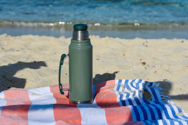 istock Authentic green Stanley Thermos on the beach in summer 2062269913