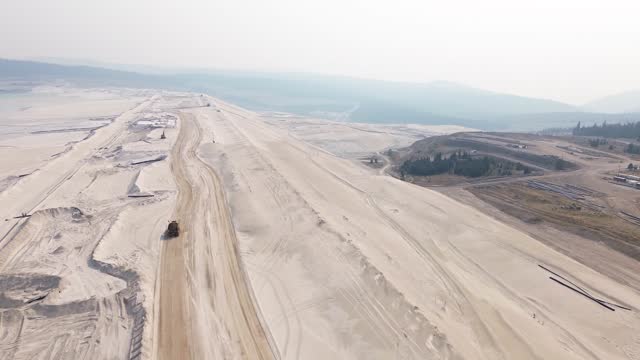 Aerial Drone Reveals Highland Valley Copper Mine Tailing Pond Viewpoint Over Sandy Terrain and Surrounding Landscape, Canada.
