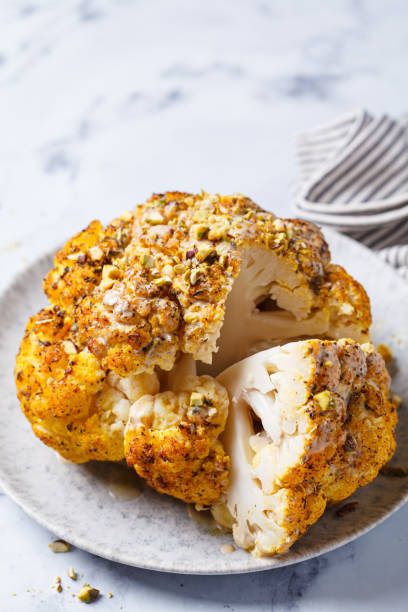 Spicy baked cauliflower with tahini dressing and pistachios.