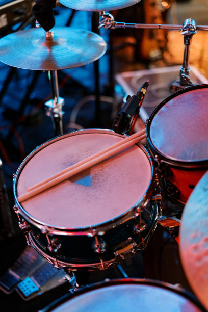 istock Pair of drumsticks lies on a drum kit on stage 2062358254