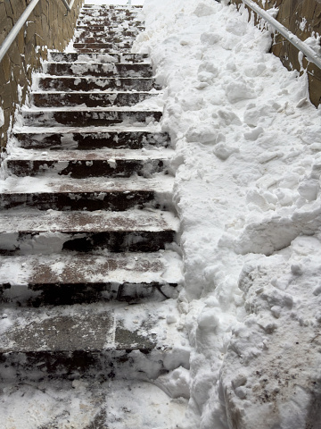 Steps on the stairs in the snow in winter.