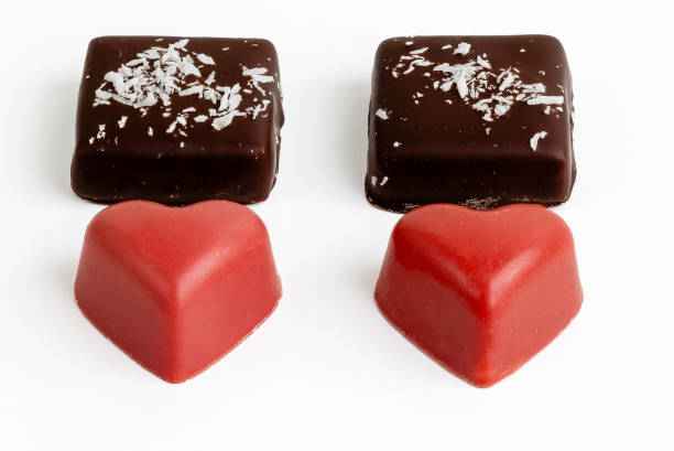 Dark chocolate valentine's dessert with white chocolate centre, on a wooden board.