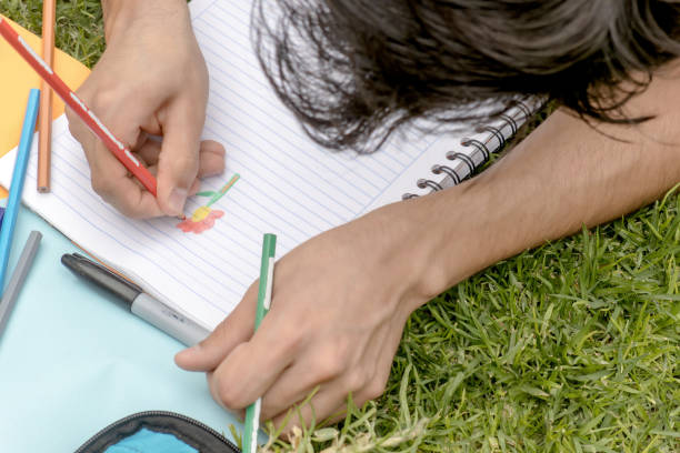 istock A person drawing a flower in a notebook 2062399748