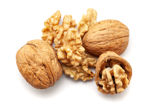 Top view of Organic cracked Walnuts (Juglans regia), isolated on a white background.