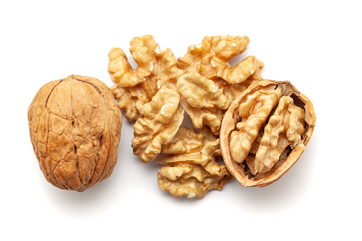 Top view of Organic cracked Walnuts (Juglans regia), isolated on a white background.