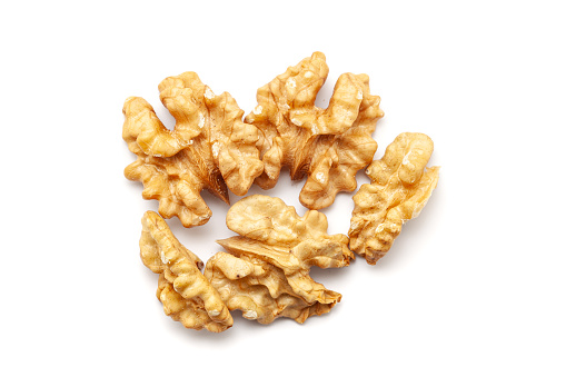 Top view of Organic cracked Walnuts (Juglans regia), isolated on a white background.